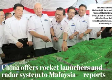  ??  ?? MALAYSIA’s Prime Minister Najib Razak and Transport Minister Liow Tiong Lai look at a model of the East Coast Rail Line at Kuantan Bahang, Malaysia Aug. 9.