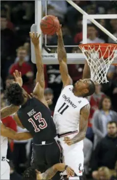  ?? GARY LANDERS — THE ASSOCIATED PRESS ?? Cincinnati’s Gary Clark (11) blocks a shot by Temple’s Quinton Rose (13) during the first half on Wednesday night in Highland Heights, Ky.