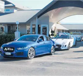  ?? ?? The cars file out of Destinatio­ns Motor Lodge on the first leg of the tour to Porangahau Hotel.