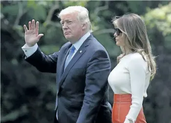  ?? ALEX WONG/GETTY IMAGES ?? U.S. President Donald Trump and first lady Melania Trump walk on the South Lawn prior to their departure from the White House May 19, 2017 in Washington, DC. President Trump is traveling for his first foreign trip to visit Saudi Arabia, Israel,...