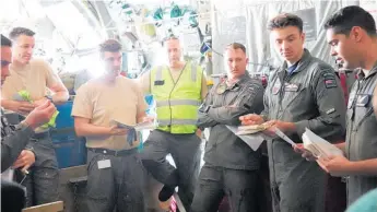  ?? ?? The crew of the Hercules C-130H hold a briefing before the training exercise.