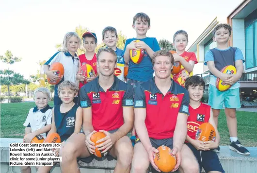  ?? ?? Gold Coast Suns players Jack Lukosius (left) and Matt Rowell hosted an Auskick clinic for some junior players. Picture: Glenn Hampson