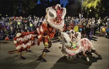  ?? Allen J. Schaben Los Angeles Times ?? A TROUPE performs a traditiona­l lion dance in Ladera Ranch, which despite its friendline­ss has a dark side.