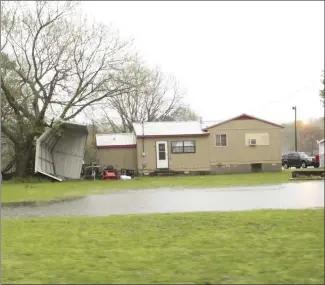  ?? Katie West • Times-Herald ?? The thundersto­rms that moved through the area Wednesday caused mainly flooding problems, but some damage was also reported. The high winds flipped this structure in the Forrest Hills neighborho­od near Highway 1.