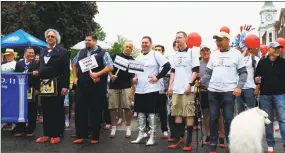  ?? N.F. Ambery / Hearst Connecticu­t Media ?? A group of participan­ts, including State Rep. Brian Ohler, holding the “change” sign at left, prepares to walk on Sunday morning.