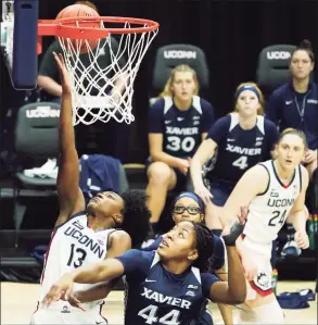  ?? David Butler II / Associated Press ?? UConn guard Christyn Williams (13) shoots and is fouled by Xavier forward Ayanna Townsend (44) in Saturday’s game in Storrs. Williams led all scorers with 24 points on 8-for-11 shooting and was 4 for 5 from 3-point range.