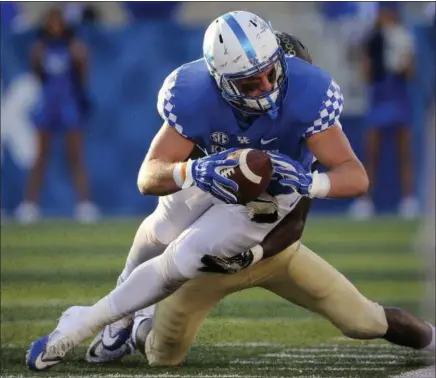  ?? DAVID STEPHENSON — THE ASSOCIATED PRESS ?? Kentucky tight end C.J. Conrad is tackled by Vanderbilt linebacker Oren Burks during a 2016 game in Lexington, Ky.