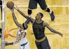  ?? CHARLES KRUPA/THE ASSOCIATED PRESS ?? Cavaliers guard Iman Shumpert, right, tips a shot by Celtics guard Isaiah Thomas on Wednesday during Game 1 of the Eastern Conference finals in Boston. Cleveland built a 26-point first-half lead and beat the Celtics, 117-104.