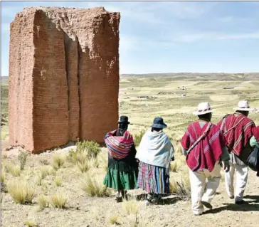  ?? AIZAR RALDES/AFP ?? Bolivian Aymara natives attend a handing over ceremony of 11 ‘chullpas’ (funerary tower) restored by the Swiss Agency for Developmen­t and Cooperatio­n at the Condor Amaya archaeolog­ical site, in Umala, 130km south of La Paz, on May 29.