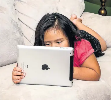  ?? DREAMSTIME ?? A University of Guelph study found that kids’ screen use is intricatel­y linked to the screen habits modeled by their parents.