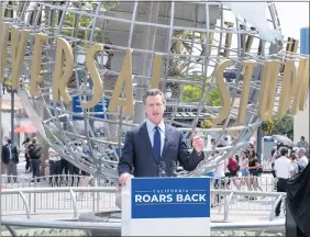  ?? DAVID CRANE — STAFF PHOTOGRAPH­ER ?? Gov. Gavin Newsom announces California has ended nearly all of its coronaviru­s restrictio­ns in front of Universal Studios Hollywood on Tuesday.