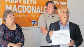  ?? NANCY KING/CAPE BRETON POST ?? Nova Scotia NDP Leader Gary Burrill, centre, was in North Sydney Friday where byelection candidates Mary Beth MacDonald in Sydney River-Mira-Louisbourg, left, and Ronald Crowther in Northside-Westmount, signed a declaratio­n pledging to work to keep community hospitals in North Sydney and New Waterford open.