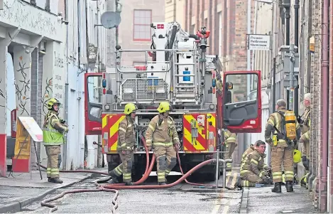  ??  ?? Fire crews at the scene of the blaze at The Venue bar building in Perth city centre.