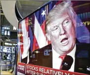  ?? RICHARD DREW / ASSOCIATED PRESS 2016 ?? An image of President-elect Donald Trump appears on a TV screen on the floor of the New York Stock Exchange after the November election. Trump repeatedly has taken credit for the market’s steady rise since he moved into the White House.