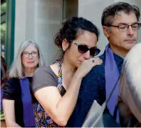  ?? — AP ?? April Muniz cries on Tom Clay’s shoulder as they wait to enter a memorial service for Heather Heyer, in Charlottes­ville.