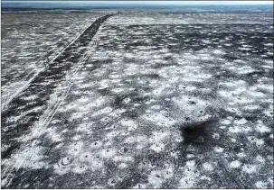  ?? ?? Months of artillery bombardmen­t around Bakhmut have left fields riddled with craters.