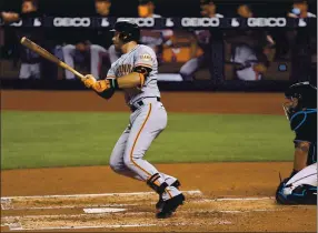  ?? MARK BROWN — GETTY IMAGES ?? Evan Longoria drives in a run for the Giants in the fourth inning of Friday’s loss to the Marlins.