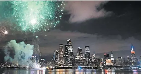  ?? KATHY WILLENS/AP ?? A surprise display of fireworks, seen from a pier across the Hudson River in Hoboken, New Jersey, explode over the Manhattan skyline late Tuesday.