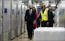  ?? Evan Vucci/Associated Press ?? President Joe Biden tours a Pfizer vaccine plant Friday in Portage, Mich. The weather has delayed the shots’ rollout.