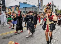  ?? CHRIS HUNT / FOR THE AJC 2018 ?? The Marching Abominable­s Seed & Feed group is one of the oldest and most popular groups that participat­e in the annual Little Five Points Halloween Parade and Festival.