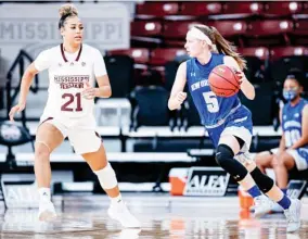  ??  ?? Mississipp­i State’s Madison Hayes (21) guards against Traya Bruce of New Orleans on Wednesday night. (Photo by Austin Perryman, MSU Athletics, for Starkville Daily News)