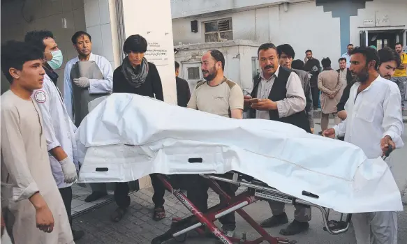  ?? Picture: AFP ?? Afghan volunteers carry a victim to a hospital following a suicide attack in Kabul that killed at least 48 people and wounded 67 others.