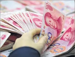  ?? AP PHOTO ?? In this 2016 file photo, a clerk counts Chinese currency notes at a bank outlet in Huaibei in central China’s Anhui province.