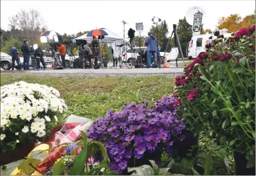  ?? Associated Press photo ?? Television networks broadcast at the roadside memorial scene of Saturday’s fatal limousine crash in Schoharie, N.Y., Monday. A limousine loaded with people headed to a birthday party ran a stop sign at the end of a highway and slammed into an SUV parked outside a store, killing all people in the limo and two pedestrian­s, officials and relatives of the victims said.