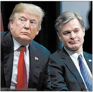  ?? AP/EVAN VUCCI ?? President Donald Trump sits with FBI Director Christophe­r Wray at graduation ceremonies Friday at the FBI Academy in Quantico, Va., after launching a scathing attack on the FBI.