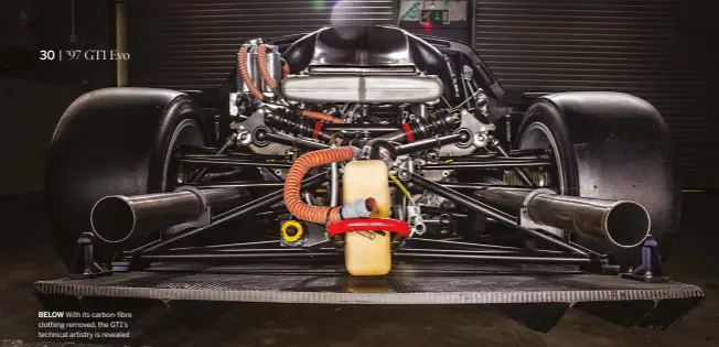  ??  ?? BELOW With its carbon-fibre clothing removed, the GT1’S technical artistry is revealed