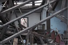  ?? PHOTOS BY AUDREY JACKSON — THE ASSOCIATED PRESS ?? A stained glass window is visible across the sanctuary of the St. James African Methodist Episcopal Church in Mayfield, Ky. A tornado on collapsed the auditorium roof and northern-facing wall.