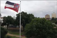  ?? ROGELIO V. SOLIS—ASSOCIATED PRESS ?? A Mississipp­i state flag flies outside the Capitol in Jackson, Miss., Thursday, June 25, 2020. Athletic coaches and their staffs from the state’s public universiti­es held a joint news conference and called for a change in the Mississipp­i state flag. Additional­ly, several head coaches met with both the lieutenant governor and Speaker Philip Gunn, as well as their lawmakers, to lobby for the change.