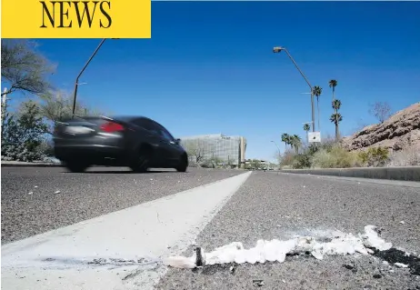  ?? CHRIS CARLSON / THE ASSOCIATED PRESS ?? Cars pass the scene in Tempe, Ariz., close to where a pedestrian was struck by an Uber vehicle Sunday night. The vehicle was in autonomous mode with an operator behind the wheel when the woman was hit. Uber suspended all of its self-driving testing...