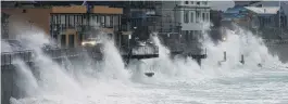  ?? PHOTO: GERARD O’BRIEN ?? Climate extremes . . . High seas lash cars driving on the Esplanade at St Clair during a winter storm in July 2017.