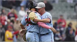  ?? STACY BENGS — THE ASSOCIATED PRESS ?? Minnesota Twins relief pitcher Emilio Pagan, right, celebrates with catcher Gary Sanchez (24) after defeating the Oakland Athletics in a baseball game Sunday in Minneapoli­s.