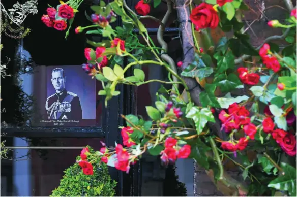  ?? EFE ?? Una foto del duque de Edimburgo y flores en su honor en la ventana de un «pub» cercano al Castillo de Windsor