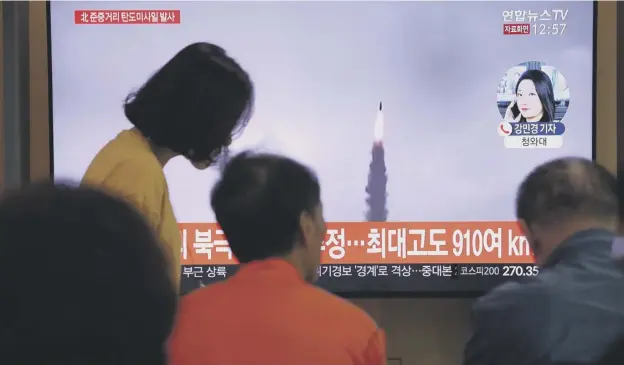  ?? PICTURE: GETTY IMAGES ?? 0 South Koreans at Seoul Railway Station watch an image of the North Korean missile launch on television