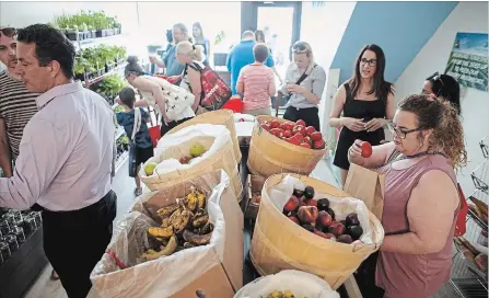  ?? COLE BURSTON THE CANADIAN PRESS ?? People shop for produce at Feed it Forward’s pay-what-you-can grocery store in Toronto on Saturday. The new store, created by Chef Jagger Gordon, left, is the first of its kind in Toronto, encouragin­g those from different socioecono­mic groups to use...