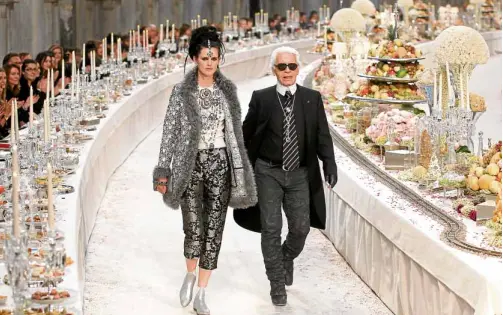  ?? —REUTERS ?? Lagerfeld with British model Stella Tennant at the finale of the India-inspired Metiers D’Art show for Chanel in December 2011.