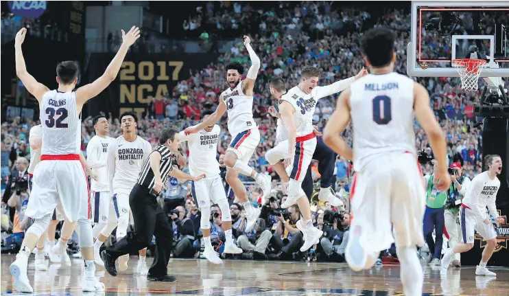  ?? — GETTY IMAGES FILES ?? Gonzaga Bulldogs teammates celebrate after defeating the South Carolina Gamecocks in the NCAA men’s Final Four semifinal on Saturday in Glendale, Ariz.