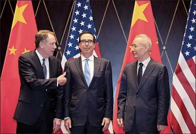  ?? AP/NG HAN GUAN ?? U.S. Trade Representa­tive Robert Lighthizer (from left) gestures to Treasury Secretary Steven Mnuchin on Wednesday as they chat with Chinese Vice Premier Liu He in Shanghai before a second day of trade talks.