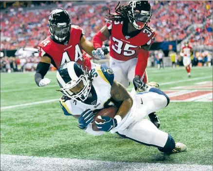  ?? Photograph­s by Wally Skalij Los Angeles Times ?? TODD GURLEY catches a 13-yard touchdown pass in front of Atlanta’s Vic Beasley Jr. (44) and Jamal Carter in the second quarter Sunday as the Rams take a 10-3 lead. Gurley ran for only 41 yards, but the Rams’ offense otherwise found its groove again.