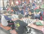  ?? SUBMITTED PHOTO ?? Chilong Vang, right and wearing a black hoodie, concentrat­es during one of his chess matches at a recent tournament. Chilong,a fifth-grader at Lincoln Middle School, won all five of his games and was named second place winner for the fifth/sixth-grade...