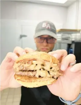  ?? BAD AS’S BURGERS ?? Chef John Collazo shows off “The Presley,” which features a cheffed-up combo of peanut butter, banana and bacon.