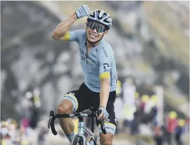  ??  ?? 0 Colombia’s Miguel Angel Lopez celebrates as he crosses the finish line on the Col de la Loze.