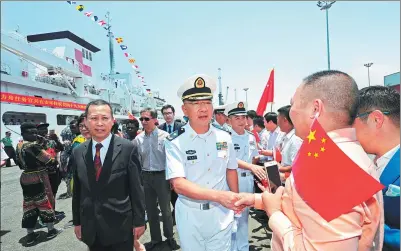  ?? JIANG SHAN / XINHUA ?? Guan Bolin (center), the mission commander of China’s naval hospital ship, the Peace Ark, greets well-wishers after the vessel arrived at the port of Luanda in Angola on Thursday. The ship, which can handle major surgeries, will provide eight days of...