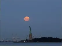 ?? PICTURE: AP ?? A supermoon glows over the Statue of Liberty, in New York. The largerthan-normal moon called a supermoon happens only once this year as the moon on its elliptical orbit is at its closest point to earth and is up to 14 percent larger than usual. The...