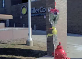  ?? MIKE DE SISTI / MILWAUKEE JOURNAL SENTINEL ?? A bouquet of roses is taped to a fire hydrant outside the Molson Coors headquarte­rs on West Highland Avenue in Milwaukee on Thursday. In one of the worst shootings in Wisconsin history, a gunman killed five people — and then himself — during a rampage Wednesday afternoon on the Milwaukee campus of Molson Coors.