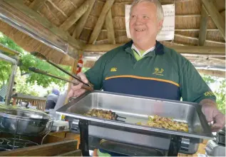  ??  ?? MEATY: Former civil engineer Danie Liebenberg serves braaied kebabs, chops and sausages to hungry visitors at the market.