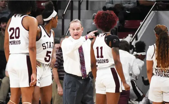  ??  ?? Mississipp­i State head women’s coach Vic Schaefer, middle, instructs his players during Monday night’s game against Georgia. (Photo by Jason Cleveland, for Starkville Daily News)